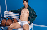 Model in the white PUMP! Deuce Boxer sitting on a courtside bench